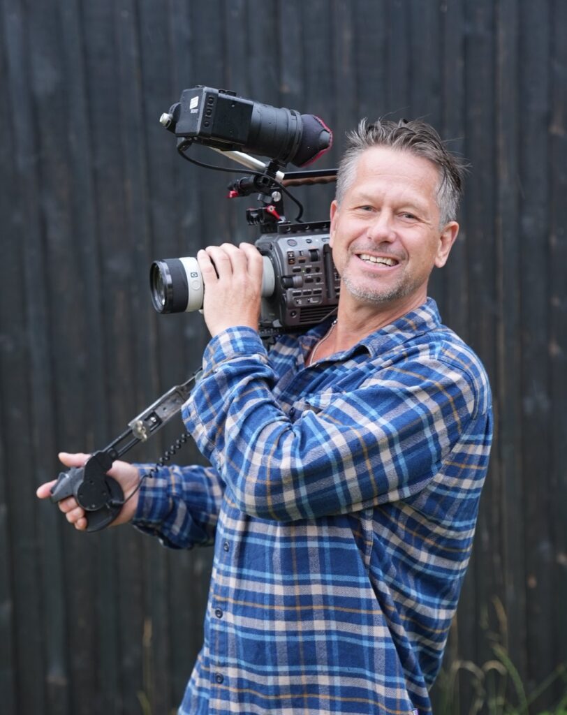 Jacob Bjelfvenstam – Swedish cameraman in Stockholm – smiling casually with professional gear, personal branding photo