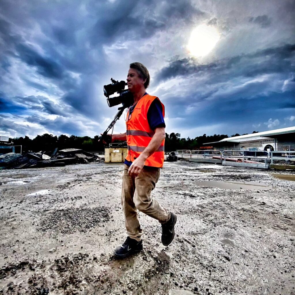 Freelance cameraman in Stockholm filming on a large construction site for an industrial video production.
